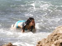 Jennifer Lawrence on the beach in a wet swimsuit