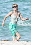 Emma Roberts on the beach in a wet swimsuit