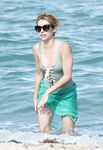 Emma Roberts on the beach in a wet swimsuit