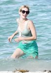 Emma Roberts on the beach in a wet swimsuit