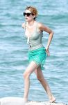 Emma Roberts on the beach in a wet swimsuit