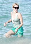 Emma Roberts on the beach in a wet swimsuit