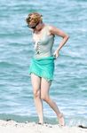 Emma Roberts on the beach in a wet swimsuit
