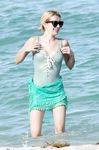 Emma Roberts on the beach in a wet swimsuit