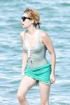 Emma Roberts on the beach in a wet swimsuit