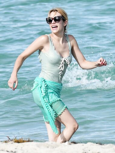 Emma Roberts on the beach in a wet swimsuit
